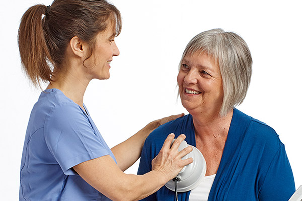 Nurse with Frequencer on Older Woman